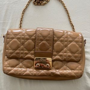 Dior Nude clutch with detachable gold handle.